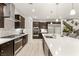 Well-equipped kitchen with a large island, stainless steel appliances, and stylish dark wood cabinetry at 4505 Amazing View St, Las Vegas, NV 89129