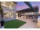 An outdoor kitchen boasts stainless steel appliances, a pizza oven, and a covered patio area at 4505 Amazing View St, Las Vegas, NV 89129