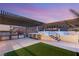 Outdoor patio featuring a full kitchen, lounge chairs, and a sleek water feature at 4505 Amazing View St, Las Vegas, NV 89129