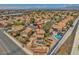Neighborhood aerial showcasing a home with backyard pool, set amongst tree-lined streets at 4548 Switchback St, North Las Vegas, NV 89031