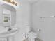 Clean half bathroom featuring sink, toilet, mirror and towel bar at 4548 Switchback St, North Las Vegas, NV 89031