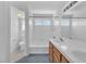 Bright bathroom featuring double sinks, white tiled shower and a separate toilet room at 4548 Switchback St, North Las Vegas, NV 89031
