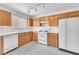 Well-lit kitchen with tiled backsplash, white appliances, and laminate countertops at 4548 Switchback St, North Las Vegas, NV 89031
