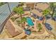Aerial view of a backyard featuring a pool with a hot tub and lush landscaping at 4548 Switchback St, North Las Vegas, NV 89031