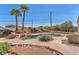 Beautiful backyard pool and spa area with rock features and desert landscaping at 4548 Switchback St, North Las Vegas, NV 89031