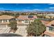 Aerial view of a two-story house with solar panels in a suburban neighborhood with mountain views at 4804 Laurentia Ave, Las Vegas, NV 89141