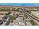 An aerial view of a neighborhood featuring homes with solar panels, lush trees and desert landscaping at 4804 Laurentia Ave, Las Vegas, NV 89141