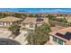 Aerial shot of a stucco house with solar panels with mountain views in suburban neighborhood at 4804 Laurentia Ave, Las Vegas, NV 89141