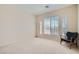 Bright bedroom featuring neutral walls, carpeted floor, and arched window letting in natural light at 4804 Laurentia Ave, Las Vegas, NV 89141