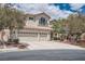 Charming stucco home with a tile roof, three-car garage and a well-maintained landscaped front yard at 4804 Laurentia Ave, Las Vegas, NV 89141