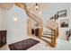 Grand foyer with a curved staircase and marble floors, showcasing an elegant entrance at 4804 Laurentia Ave, Las Vegas, NV 89141