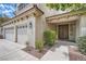 Inviting front entrance with a three-car garage and classic double doors at 4804 Laurentia Ave, Las Vegas, NV 89141