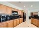 Modern kitchen with black granite countertops, stainless steel appliances, and ample cabinet space at 4804 Laurentia Ave, Las Vegas, NV 89141