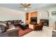 Cozy living room with ceiling fan, built-in shelving, fireplace, and leather furniture at 4804 Laurentia Ave, Las Vegas, NV 89141