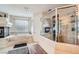 Bathroom featuring a soaking tub, walk-in shower, and neutral tile at 4804 Laurentia Ave, Las Vegas, NV 89141