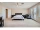 Large bedroom with carpet, simple furnishings, and access to the outside at 4804 Laurentia Ave, Las Vegas, NV 89141