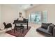 Cozy sitting room with a piano, sofa, and natural light from the window at 4804 Laurentia Ave, Las Vegas, NV 89141
