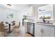 Bright kitchen featuring stainless steel appliances, quartz counters and an open layout to the dining area at 50 Armstrong Cir, Henderson, NV 89015