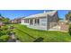 Spacious backyard showcasing lush green lawn and mature shrubbery at 5000 Linkside Dr, Las Vegas, NV 89130