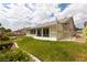 Spacious backyard featuring a covered patio, lush lawn, and mature landscaping at 5000 Linkside Dr, Las Vegas, NV 89130