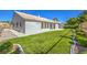 Expansive backyard view featuring manicured lawn and mature shrubbery at 5000 Linkside Dr, Las Vegas, NV 89130