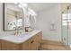 Modern bathroom featuring double sinks, a glass enclosed shower, and luxury gold hardware at 5000 Linkside Dr, Las Vegas, NV 89130