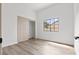 Bedroom featuring ample natural light from a large window, complemented by wood-look flooring and a closet at 5000 Linkside Dr, Las Vegas, NV 89130