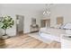Spacious bedroom offering wood floors, neutral tones, modern decor, and access to ensuite bath at 5000 Linkside Dr, Las Vegas, NV 89130