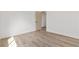Empty bedroom featuring wood-look floors, a white door, and ample natural light at 5000 Linkside Dr, Las Vegas, NV 89130