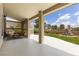 Beautiful covered patio with seating area overlooking a landscaped backyard with a water feature at 5000 Linkside Dr, Las Vegas, NV 89130