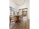 The dining area features a round wood table with a modern light fixture and access to the patio at 5000 Linkside Dr, Las Vegas, NV 89130