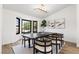 Dining room with a large bay window and modern décor including a black table and decorative horse at 5000 Linkside Dr, Las Vegas, NV 89130