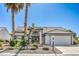 Charming single-story home featuring a well-maintained landscape and an attached two-car garage at 5000 Linkside Dr, Las Vegas, NV 89130