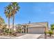 Charming single-story home with beautiful landscaping and mature palm trees at 5000 Linkside Dr, Las Vegas, NV 89130