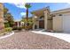 Charming single story home featuring desert landscaping, an arched entry, and covered front porch at 5000 Linkside Dr, Las Vegas, NV 89130