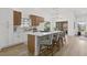 Bright open kitchen with stainless appliances, an island with bar seating, and white countertops at 5000 Linkside Dr, Las Vegas, NV 89130