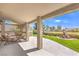 Comfortable covered patio with an outdoor seating area and landscaped yard at 5000 Linkside Dr, Las Vegas, NV 89130
