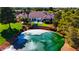Aerial view of a pristine pond with a fountain, surrounded by lush landscaping and a clubhouse at 5000 Linkside Dr, Las Vegas, NV 89130