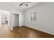 Simple bedroom with wood-look flooring, window, and walk-in closet for storage at 5250 S Rainbow Blvd # 2106, Las Vegas, NV 89118
