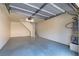 Spacious attached garage with painted floors, stairway, and water heater at 5250 S Rainbow Blvd # 2106, Las Vegas, NV 89118
