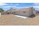 The back of the house has stucco siding, a gravel yard, a tile roof, and a small patio at 540 Kelsford Dr, Las Vegas, NV 89123