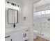 Stylish bathroom featuring modern black fixtures, a walk-in shower, and white cabinets at 540 Kelsford Dr, Las Vegas, NV 89123