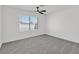 Bright bedroom with gray carpet, ceiling fan, and window offering outside views at 540 Kelsford Dr, Las Vegas, NV 89123