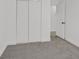 Bedroom featuring neutral carpet, white walls, and a closet with sliding doors at 540 Kelsford Dr, Las Vegas, NV 89123