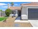 Close up of inviting home entrance and front yard featuring well-maintained landscaping at 540 Kelsford Dr, Las Vegas, NV 89123