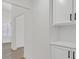 Bright hallway featuring hardwood floors, white walls, and white built-in cabinets at 540 Kelsford Dr, Las Vegas, NV 89123