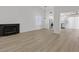 Spacious living room featuring new flooring, fresh paint, open layout to kitchen, and a fireplace at 540 Kelsford Dr, Las Vegas, NV 89123