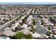 Expansive aerial view of a suburban community showcasing rows of single-Gathering homes in a desert landscape at 6032 Red Glitter St, North Las Vegas, NV 89031