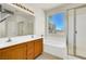 Spacious bathroom featuring a dual sink vanity, a large mirror and a walk-in shower at 6032 Red Glitter St, North Las Vegas, NV 89031