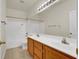 This bathroom features double sinks, tile floors, and a bathtub shower combo at 6032 Red Glitter St, North Las Vegas, NV 89031